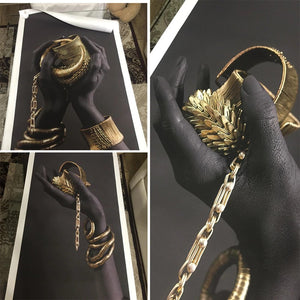 Black Hands Holding Golden Jewellery Canvas Art